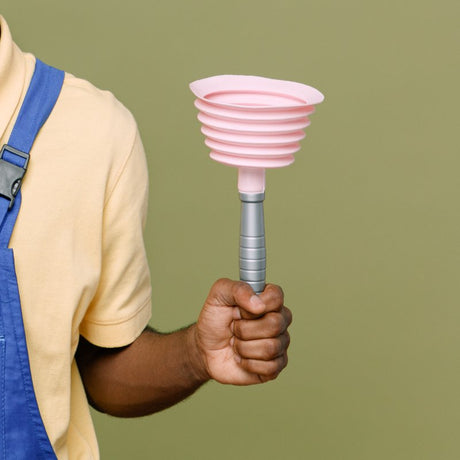 A man holding a pink funnel on a green background.